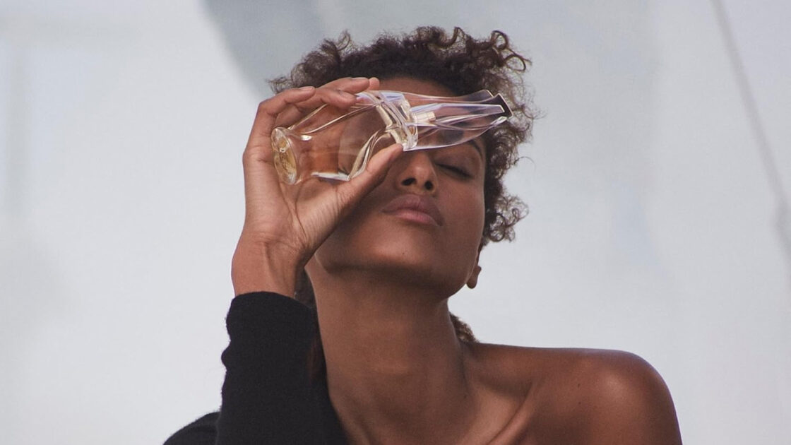 Donna Karan Cashmere Mist Bottle Held by Model